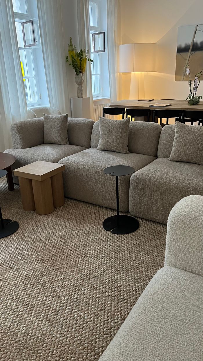 services-01 A warm and inviting living room with plush sofas, neutral tones, and simple decor accents.